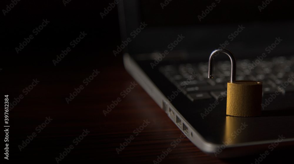 Fototapeta premium open security lock on laptop keyboard. Concept of Cyber security breach 