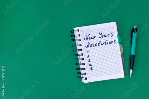 New Year's resolutions concept. New Year's resolutions on a green background. Flat lay.