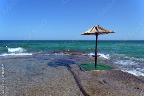 Umbrella in the sand on the deserted beach.Beach umbrella .