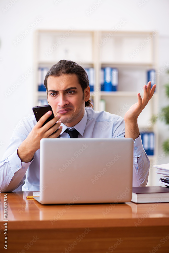 Stressed male employee working in the office Stressed male employee working in the office