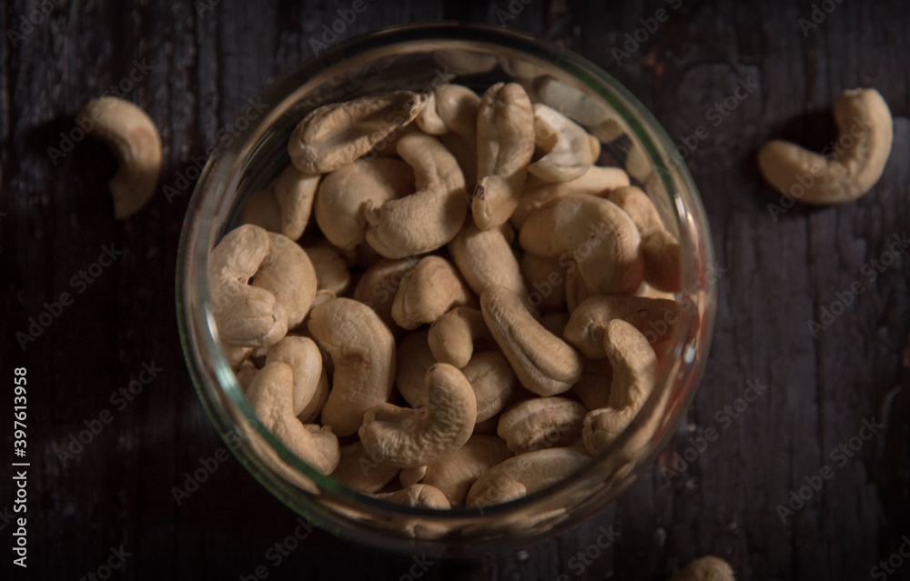 cashew nuts in bowl on dark wooden table cashew nuts in bowl on dark wooden table