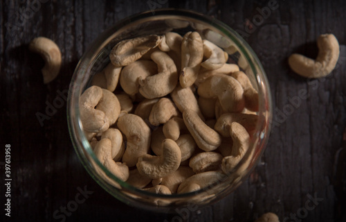 cashew nuts in bowl on dark wooden table