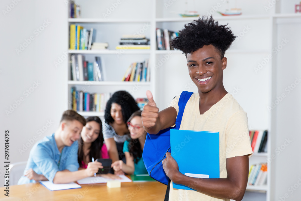 Fototapeta premium African american male student with eyeglasses and group of international students