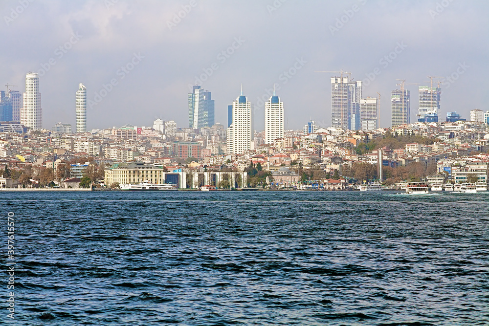 View of Besiktas municipality with skyscrapers of Levent business district from the Bosphorus strait in Istanbul, Turkey