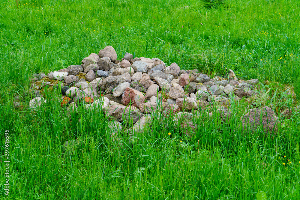 pile of rocks pebbles in green meadow pile of rocks pebbles in green meadow