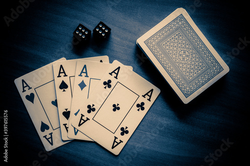 A deck of playing cards and two dice are on the Table.