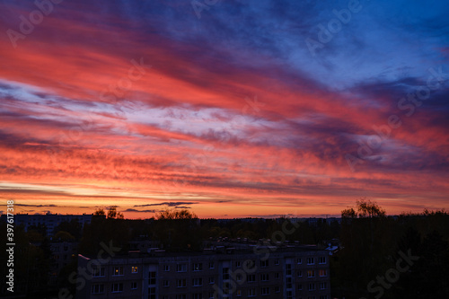 dramatatic red dark sunset over the fields and cities photo