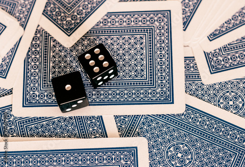 two dice are placed on playing cards