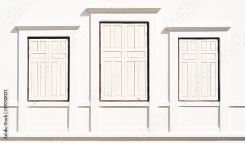 Three white windows on white wall