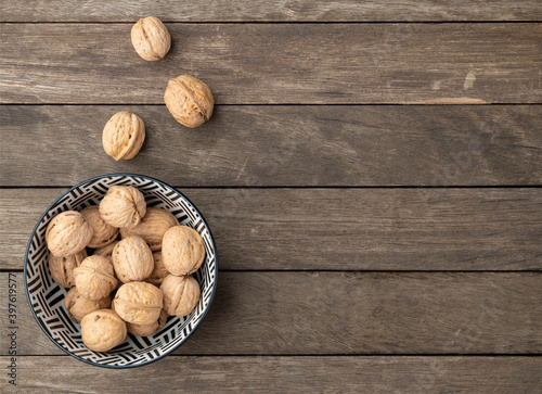 Walnuts over a wooden table with copy space