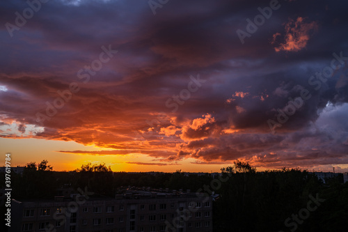 dramatatic red dark sunset over the fields and cities photo