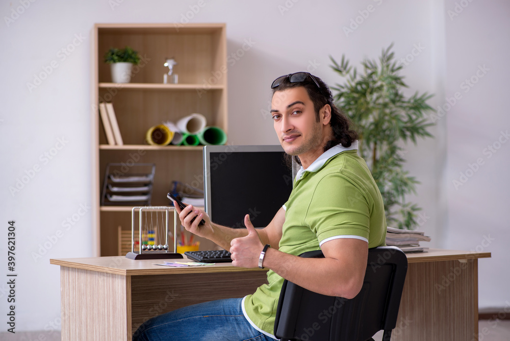 Young male designer working in the office