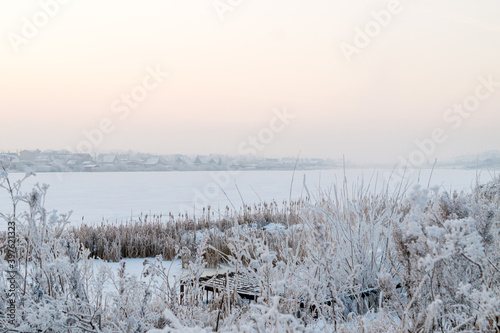 Fototapeta Naklejka Na Ścianę i Meble -  Winter landscape. Frozen lake on a frosty evening