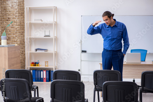 Young male business trainer making presentation during pandemic