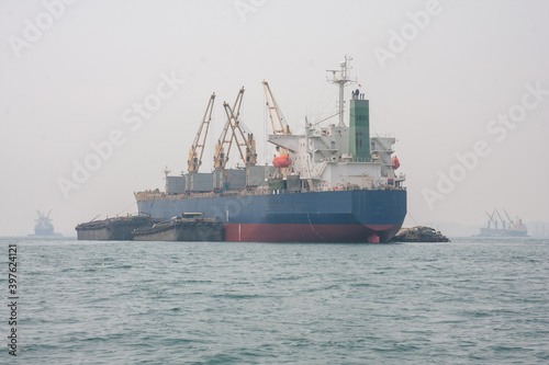 A large container ship sailed in the middle of the sea.