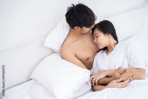 Couple Asian man and woman on bed