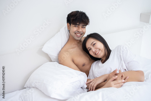 Couple Asian man and woman on bed