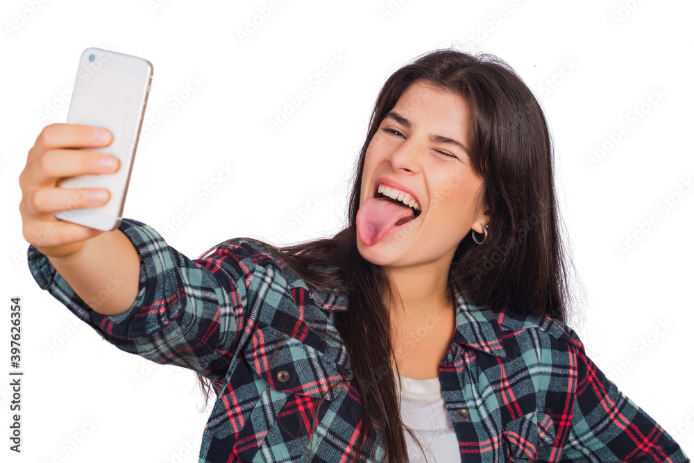 Young woman taking a selfie with phone. Young woman taking a selfie with phone.
