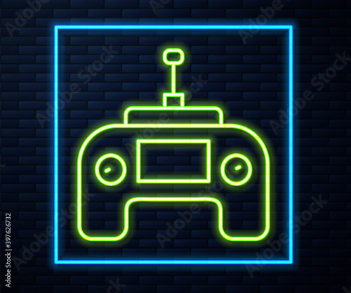 Glowing neon line Drone radio remote control transmitter icon isolated on brick wall background. Vector.