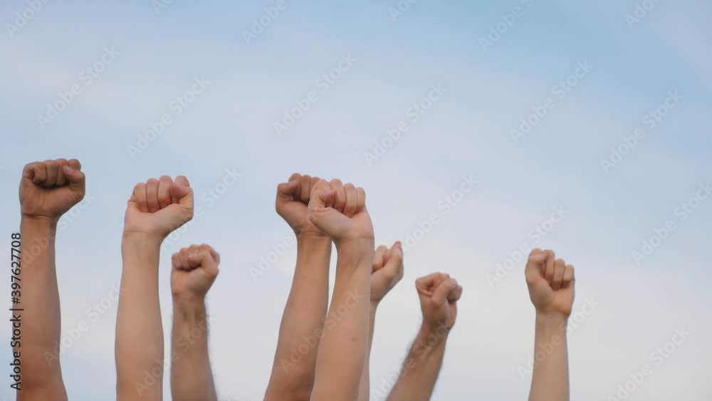 Teamwork. A group of people against the sky raises their hands up. The concept of voluntary voting, expression of consent, support for democracy. Teamwork. A group of people against the sky raises their hands up. The concept of voluntary voting, expression of consent, support for democracy.
