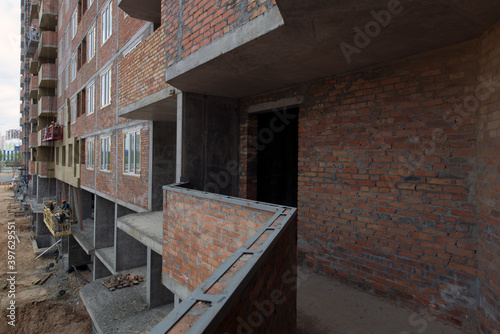 Wall of a multi-storey building  installation of windows. Production of apartments  social housing.