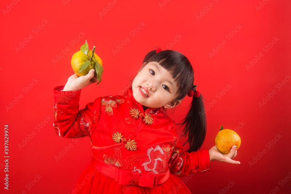 A Chinese girl holding oranges for the Spring Festival A Chinese girl holding oranges for the Spring Festival
