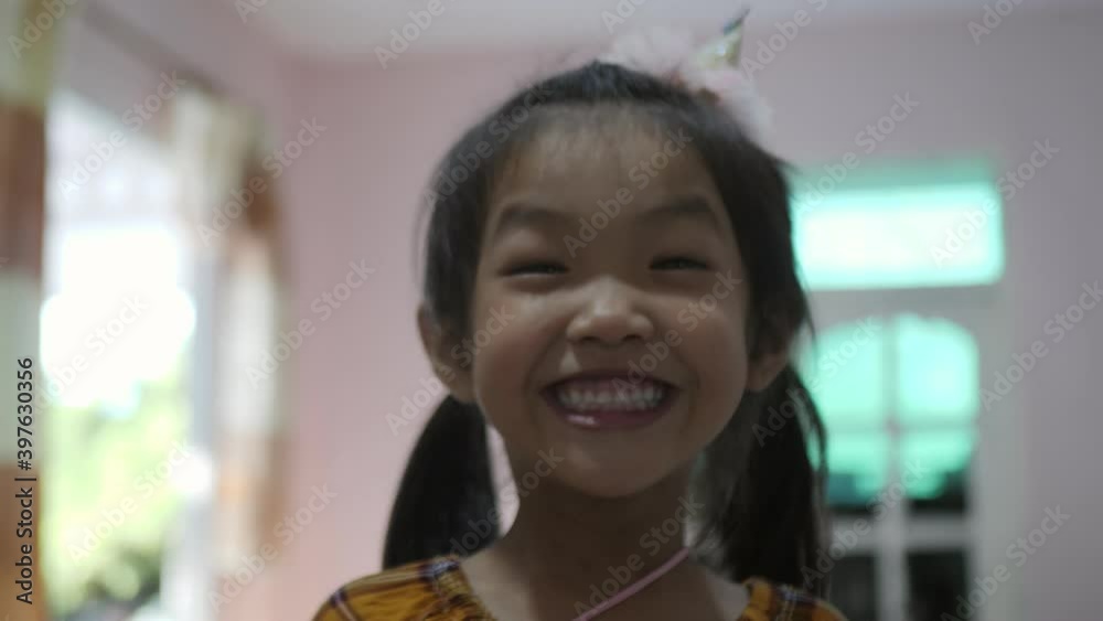 Slow motion scene of A 4-year-old girl from ASEAN is smiling with radiance
