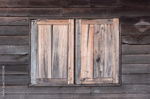 Antique double wooden windows in a wooden house. © Nippich