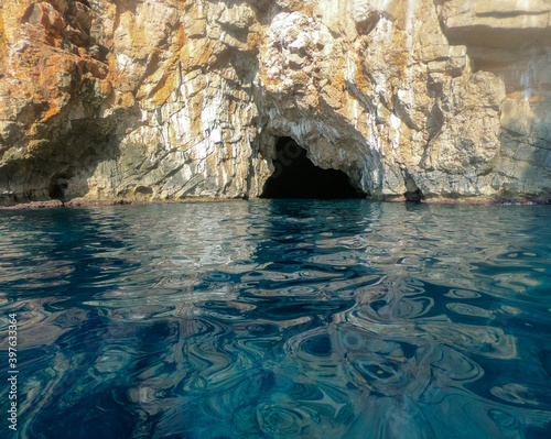 entrance to the cave in the rock from the sea. photo