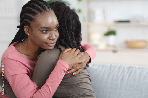 Canvas Print Closeup of dishonest woman hugging her crying girlfriend