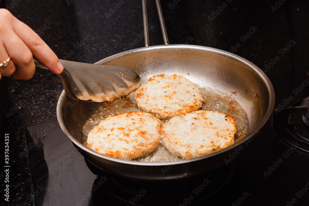 Frying the burgers in the turkey breast burger pan