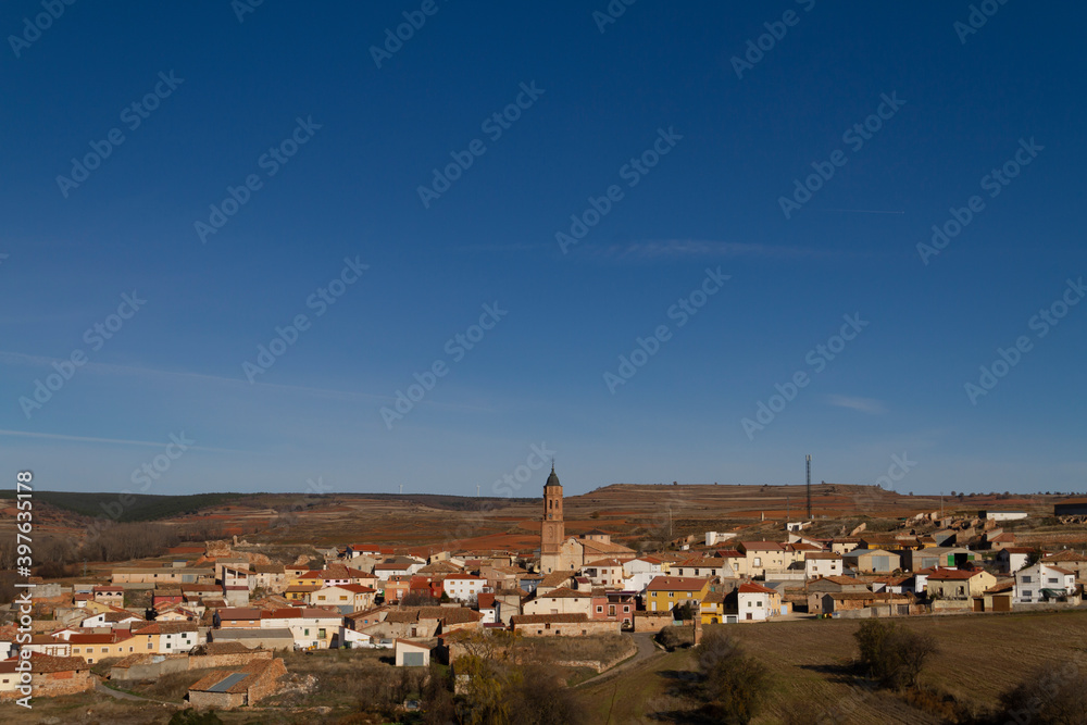 View of the Torrecilla del Rebollar town in the province of Teruel, Jiloca county, with the tower of the Church of San Cristóbal in the center
