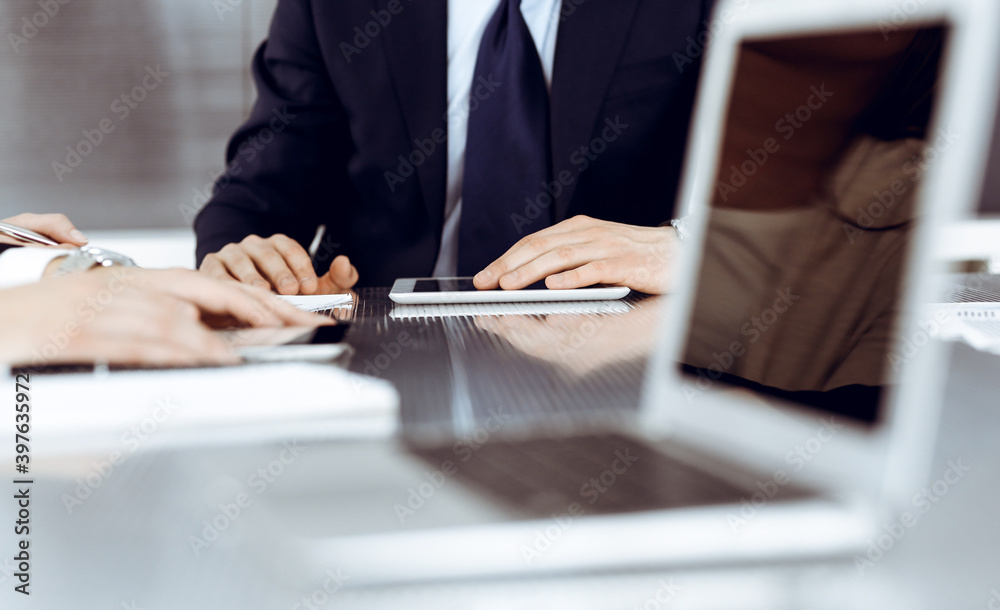 Fototapeta premium Business people working together at meeting in a modern office. Unknown businessman and woman with colleagues or lawyers at negotiation about contract