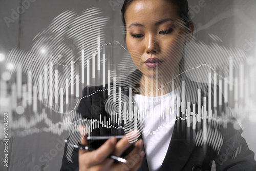 Businesswoman typing phone, work in modern office on new project. forex graph hologram. Double exposure. Concept of success in online trading. Mobile app.
