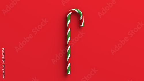 Mint hard candy cane striped in Christmas colours isolated on a red background. 