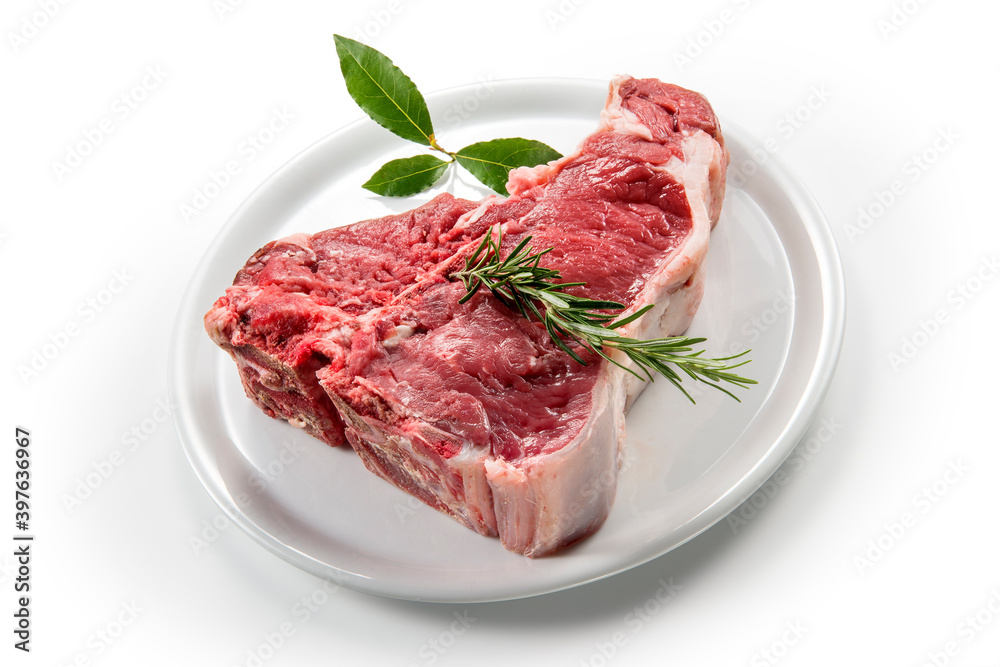 Raw T-bone steak with bay leaf and rosemary