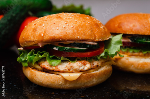 Homemade cheeseburger made from turkey. The ingredients used were poultry breast, cucumber, tomato, lettuce, cheese and sauce.