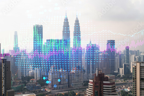 Financial stock chart hologram over panorama city view of Kuala Lumpur. KL is the business center in Malaysia  Asia. The concept of international transactions. Double exposure.