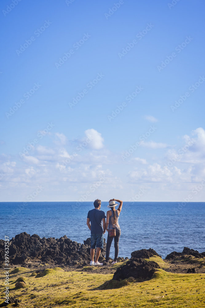 Young romantic couple standing in front of the Indian Ocean in Cap Méchant bay in Reunion Island
