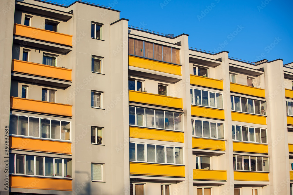 Exterior of apartment building on a blue sky background. No people. Real estate concept. Exterior of apartment building on a blue sky background. No people. Real estate concept.
