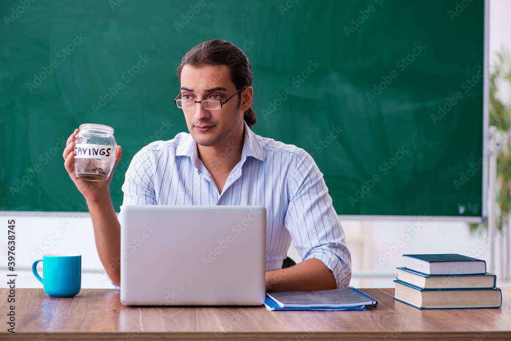 Young male teacher in remuneration concept Young male teacher in remuneration concept