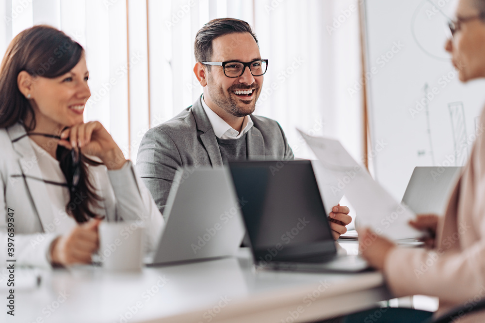 Portrait of cheerful elegant businessman smiling at the meeting Portrait of cheerful elegant businessman smiling at the meeting