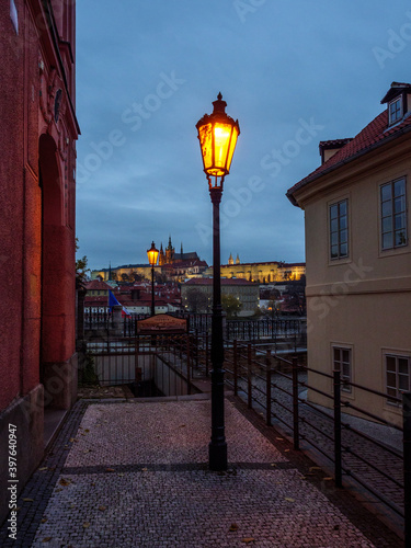 Historic street in Prague's city center with the view on Prague Castle in the evening