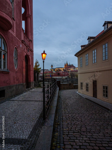 Historic street in Prague's city center with the view on Prague Castle in the evening