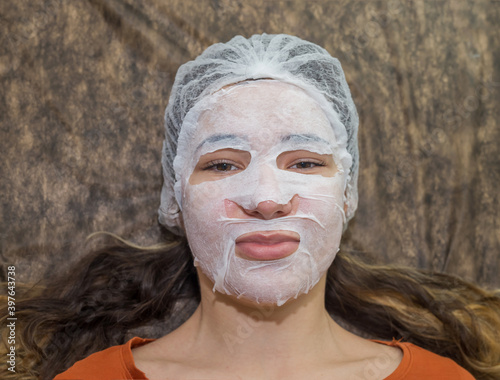 A woman in a beauty salon during a facial skin care treatment