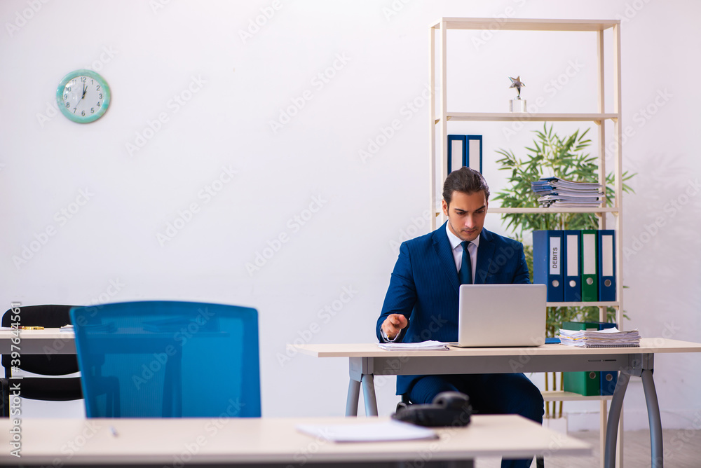 Young male employee working in the office Young male employee working in the office