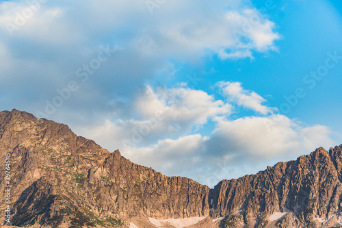 Blue sky and clouds over the rocks, beautiful cloud landscape over mountain range © Koirill