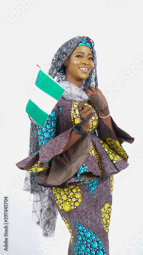 Portrait of pretty Nigerian Hausa girl waving the Nigerian Flag  photo
