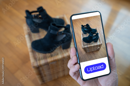 Принти на полотні View of a person taking a photo of a pair of shoes to upload in a second hand cl