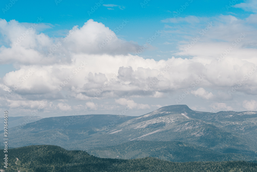 Blue sky and clouds over the rocks, beautiful cloud landscape over mountain range Blue sky and clouds over the rocks, beautiful cloud landscape over mountain range